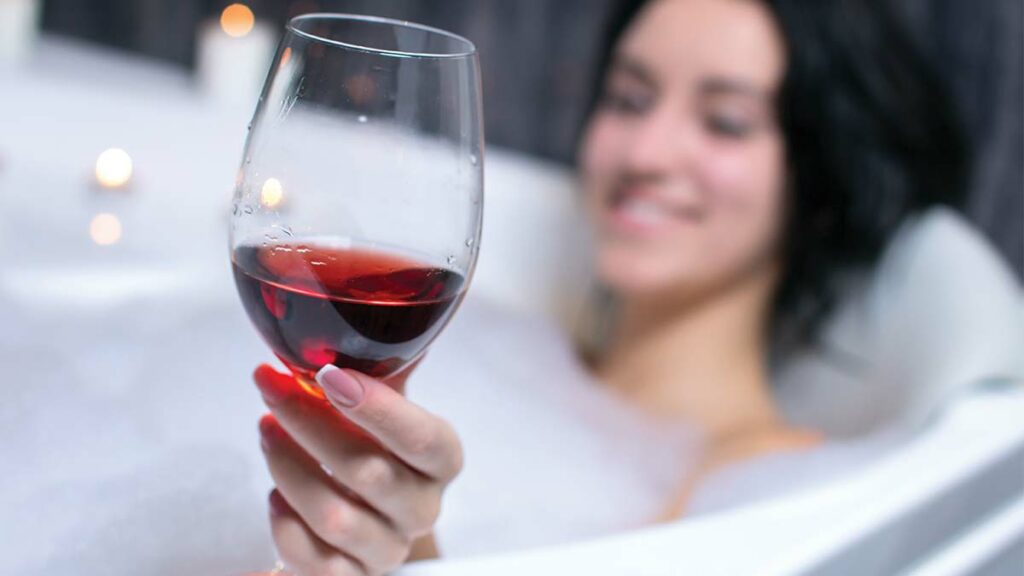 drinking wine in the jacuzzi