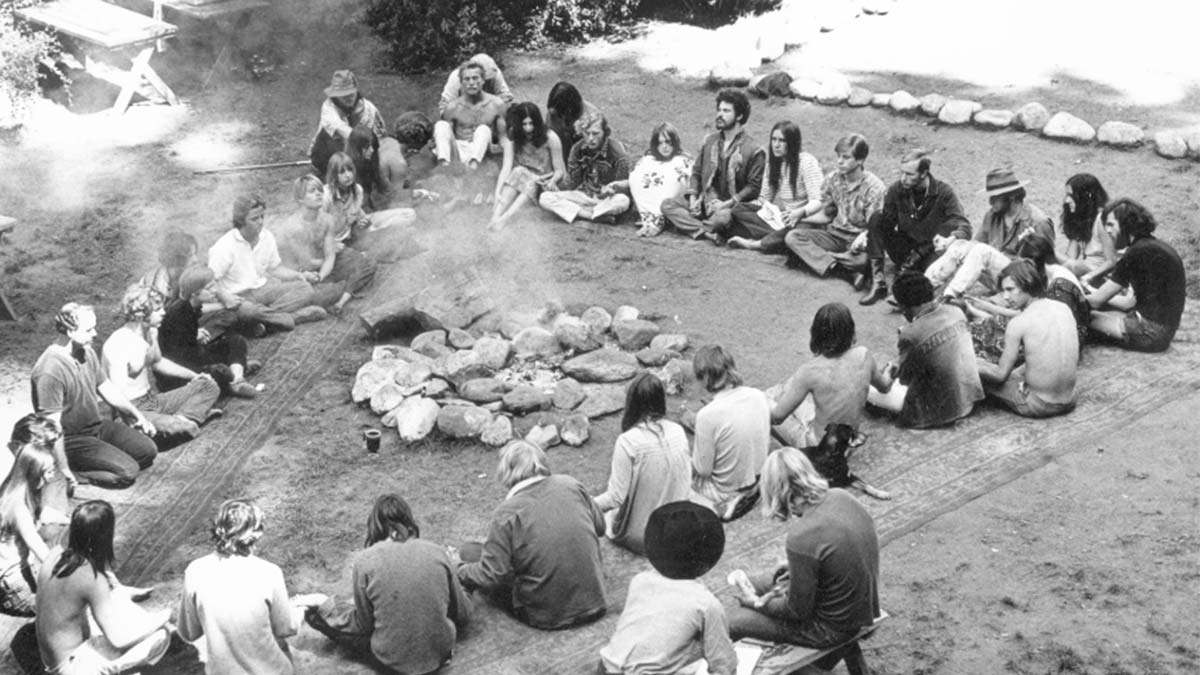 Residents of Ben Lomond's Holiday Cabins commune sit in a circle outside