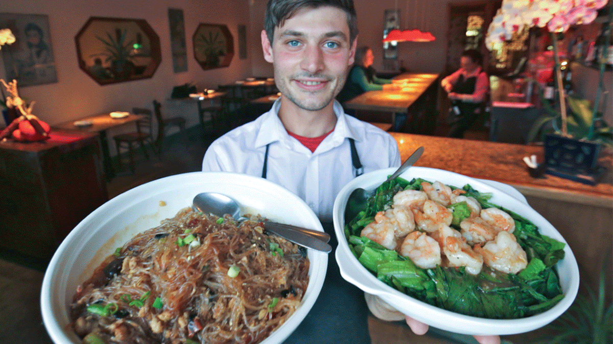 Jordan Chesko of Oâ€™mei with â€˜Ants Climbing a Treeâ€™ dish and garlic prawns with bok choy.