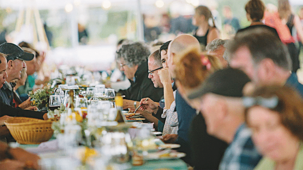 Sustain Supper 2016 diners outside at a long table