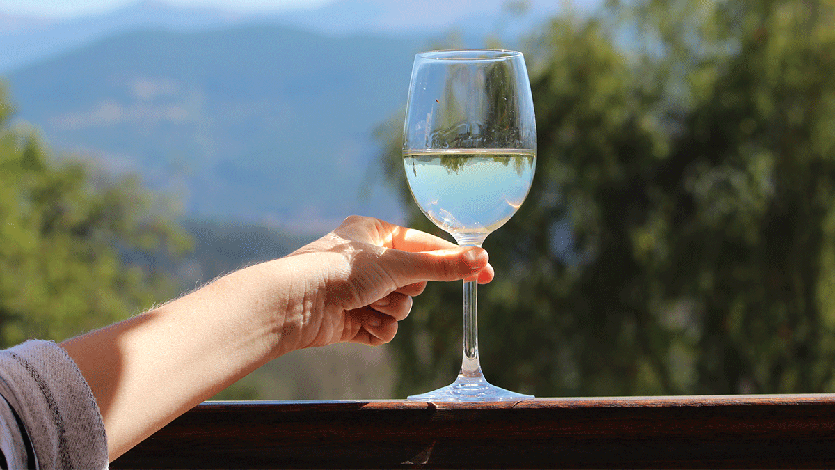 Margins Wine white wine on a porch in front of mountains