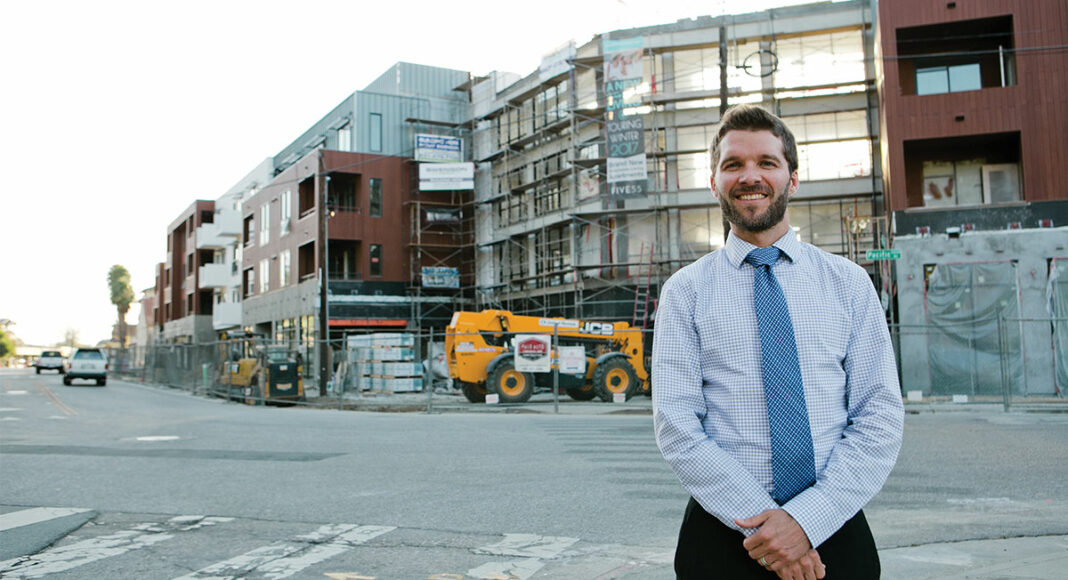 Lee Butler, the new planning and community development director, stands in front of construction of the 555 Pacific Avenue condos, part of conversation affordable housing rules