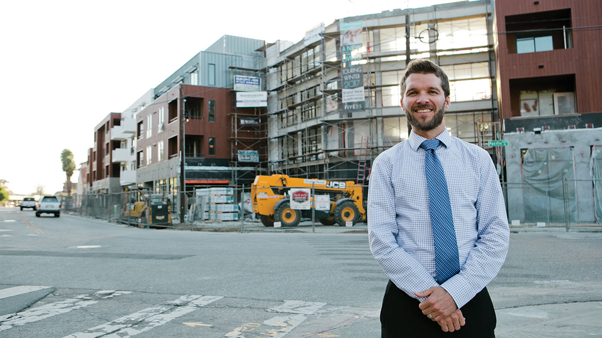 Lee Butler, the new planning and community development director, stands in front of construction of the 555 Pacific Avenue condos, part of conversation affordable housing rules