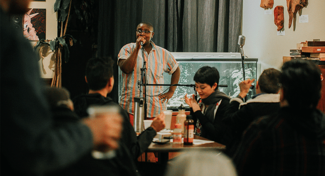 Ezra Bowen, the new transgender program coordinator for the Diversity Center, addresses the crowd at a recent open mic. PHOTO: KEANA PARKER