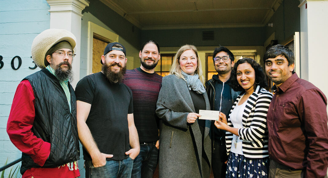 Karma Khana presents Anissa Novak of the Walnut Avenue Family & Women's Center with a $900 check. Left to right: Allen Laine, Ross Albert, Sean McGowen, Novak, Amit Khatri, Kavya Iyer and Varun Raghavan.