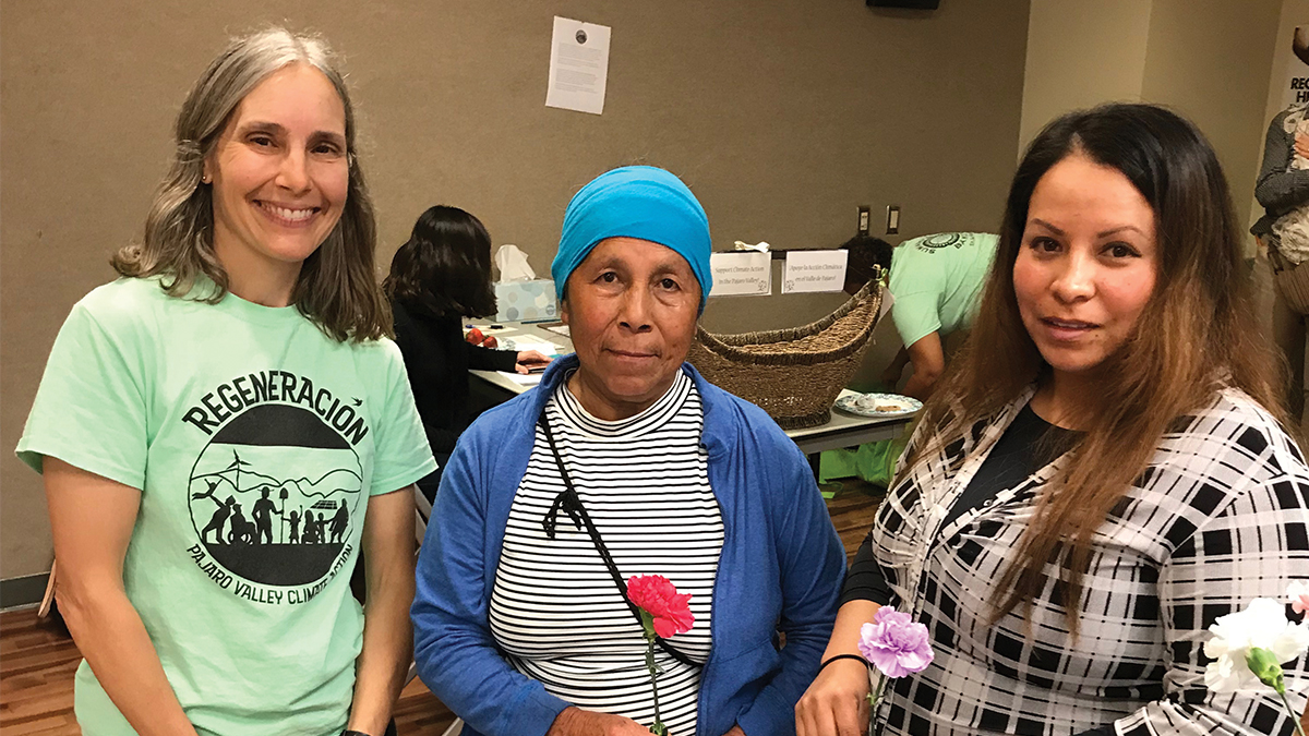 climate change impacts, Nancy Faulstich, coordinator of the ‘Regeneración: Climate of Hope’ study, stands with two local farm workers at an unveiling of the climate change data in Watsonville.