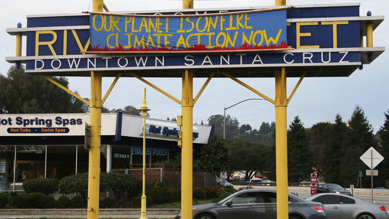 Activists Hang Banner Calling for Climate Action on River Street Sign