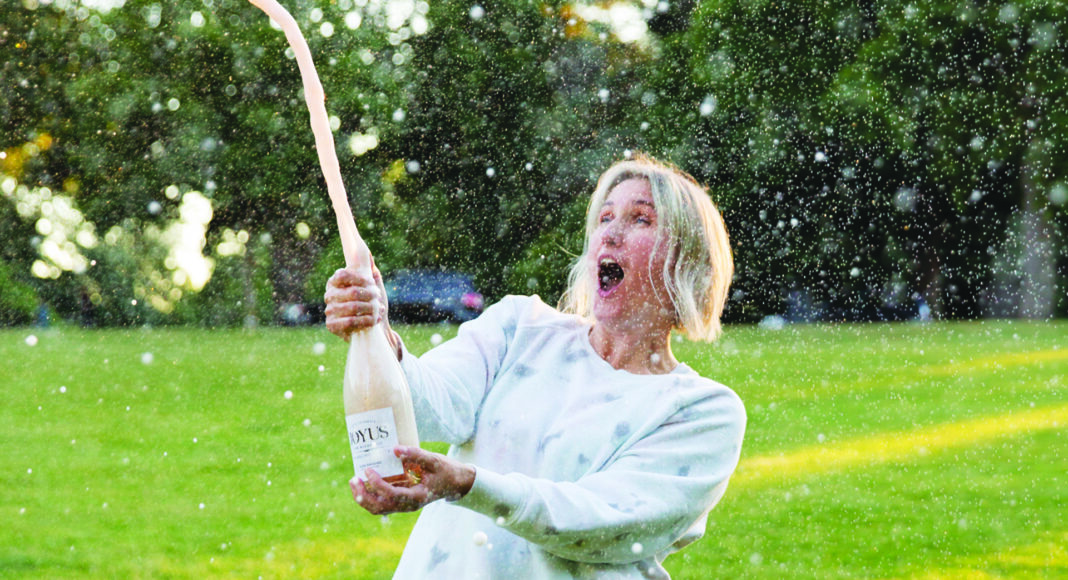 Popping a cork of sparkling wine bottle
