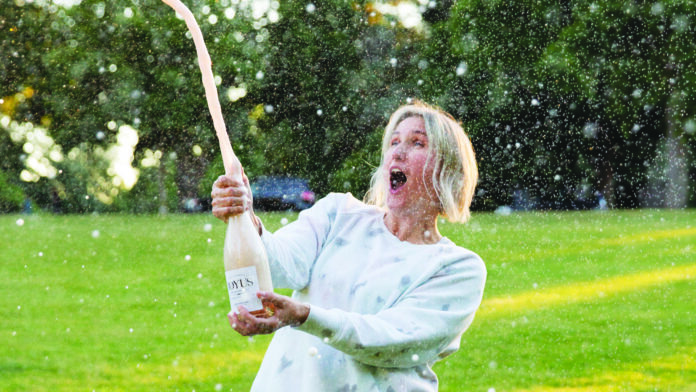 Joyus Popping a cork of sparkling wine bottle
