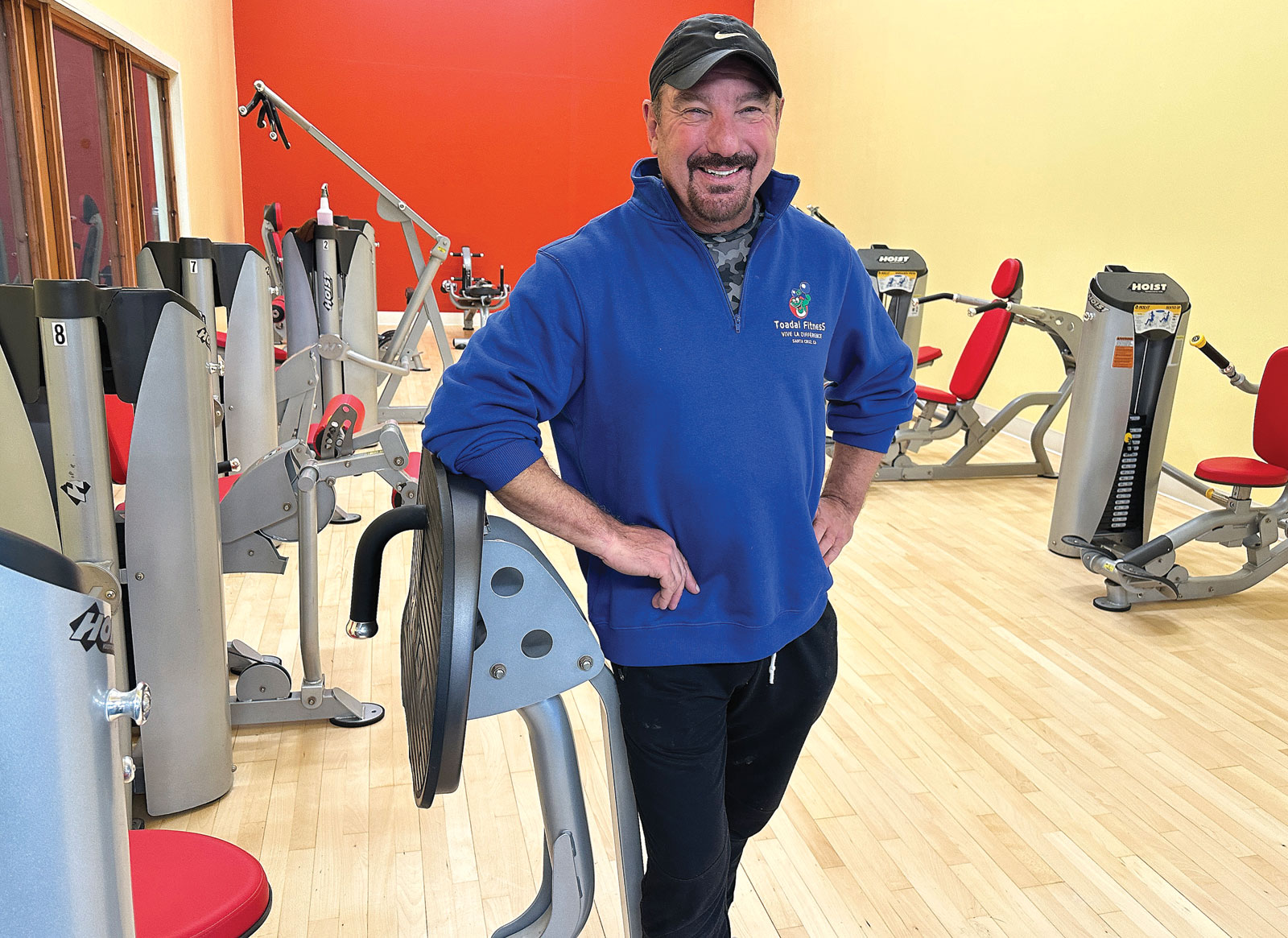 Man standing by exercise equipment in a gym