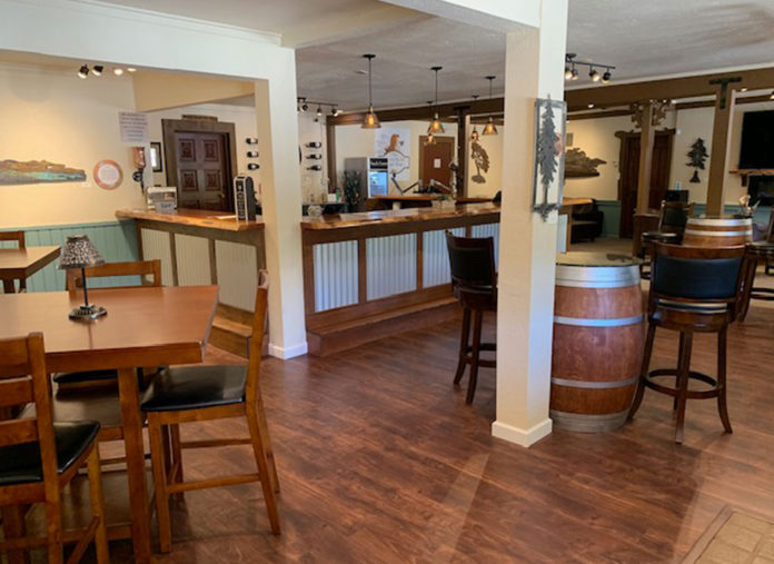 Kissed by an Angel Serves Up Cabernet Franc and More Empty tasting room with bar, wine barrel and tables
