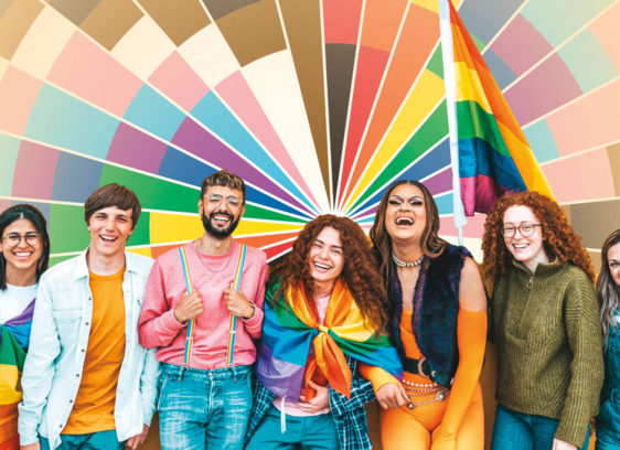 Santa Cruz Pride’s 49th Weekend! Group of happy people before a colorful geometric background.