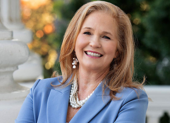 Gail Pellerin Addresses New State Housing Laws Blond woman wearing a jacket and pearls, photographed outdoors