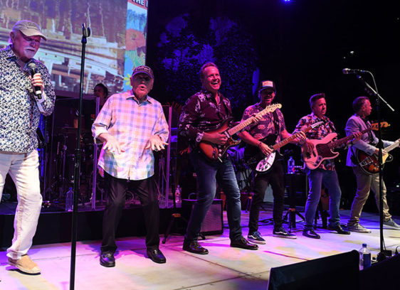 Surf’s Still Up: How the Beach Boys Drew Us to California Musicians lined up on a stage