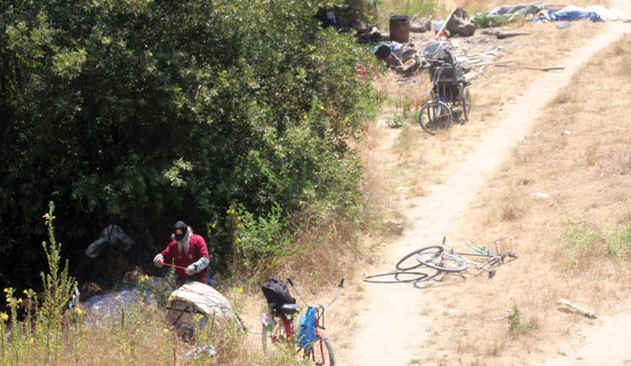 Homeless Camp Cleared Along Pajaro River Man clearing possessions from his outdoor campsite