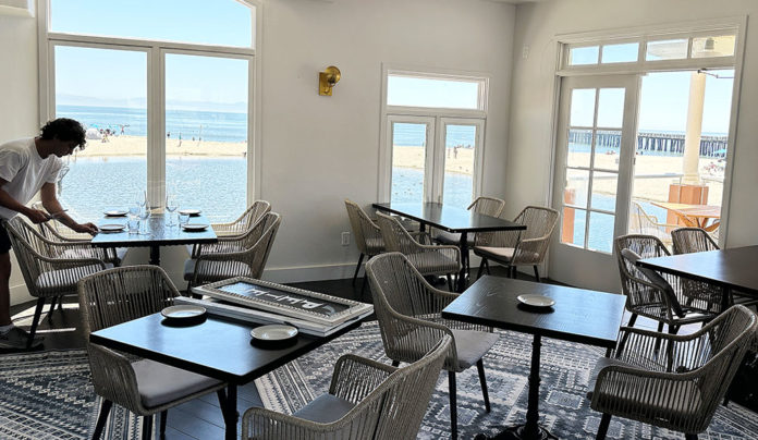 Keep Trucking Daniel Dabney sets a table inside the new Pete’s Fish House restaurant in Capitola Village.