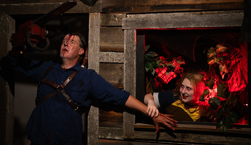 Evil Dead characters Ash Williams (played by Marcus Boardman) and Cheryl (Fey Triona) battle demons.