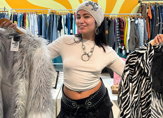 Slow Fashion girl holding a shaggy fur coat and and a faux zebra skin coat