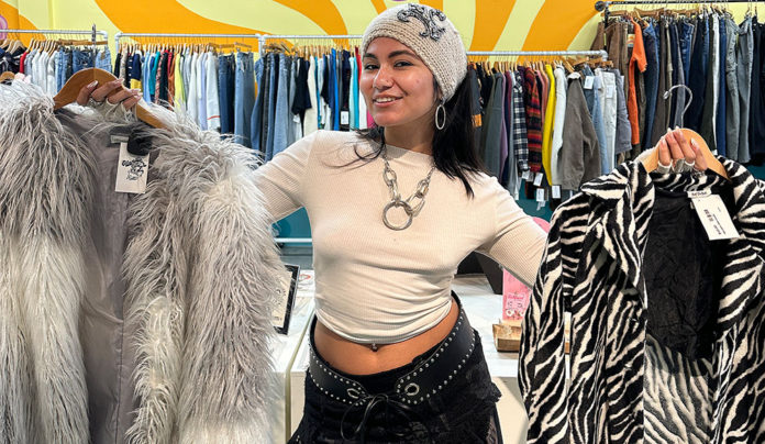 Slow Fashion girl holding a shaggy fur coat and and a faux zebra skin coat