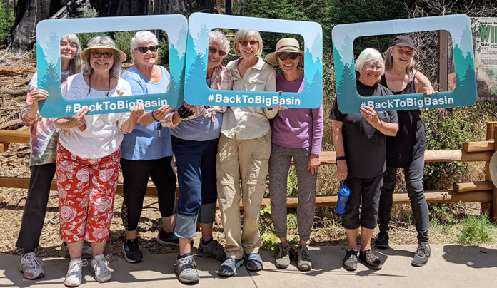 Village Santa Cruz County Builds Generational Bridges Group of people holding up signs that frame their faces and say "BackToBigBasin"