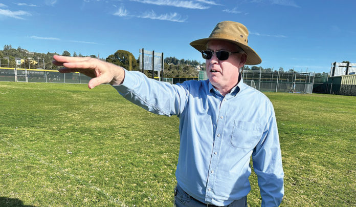 Cabrillo College Housing Project Takes Shape Man in a hat on a soccer field pointing
