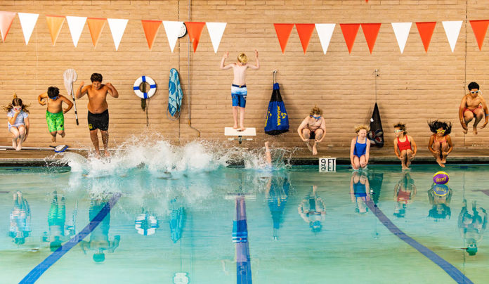 Boys and Girls Club Keeps Kids in the Swim A row of kids jumping into a swimming pool