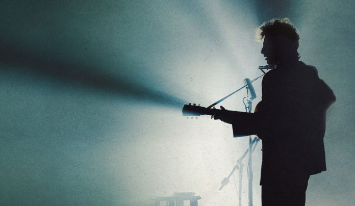 Visions of Dylan Man playing the guitar on stage, in silhouette