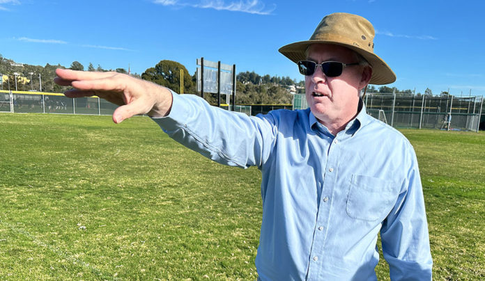 Cabrillo College President Matt Wetstein Announces Retirement Man standing in a field with his arm raise