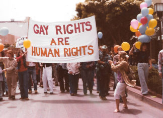 Out of the Closet and Into the Streets cover story image: a gay rights banner