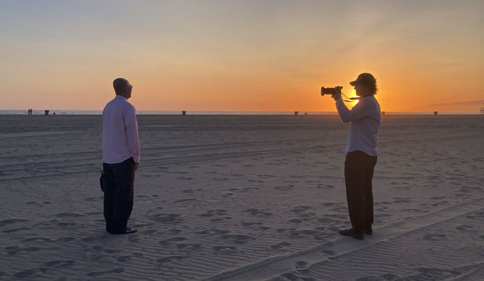 Modern-Day Slavery Person with a camera interviewing someone on the beach