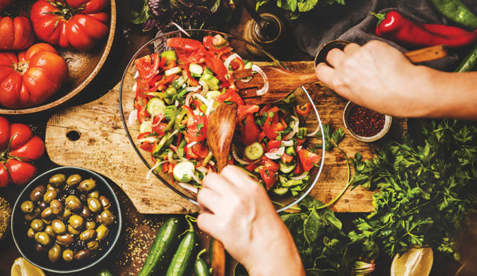 Clean and Coastal wellness image tossing salad