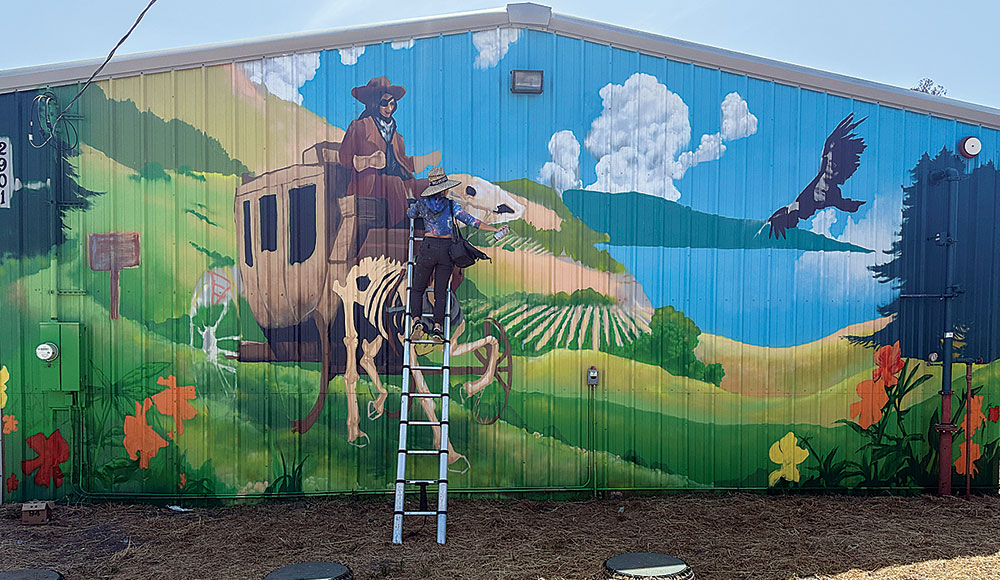 Woman painting a mural
