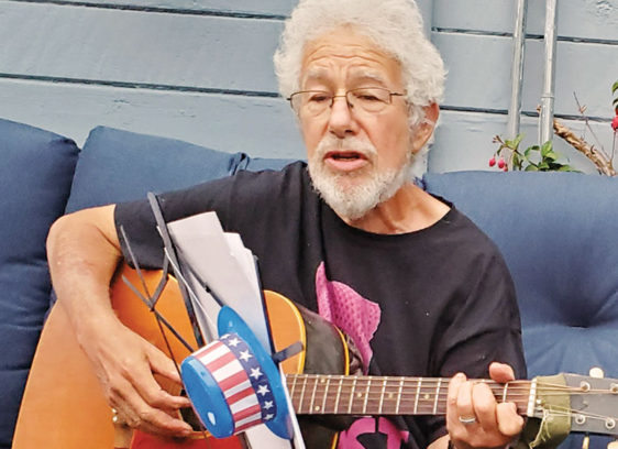 Mike Rotkin, 1945-2025 Man playing a guitar