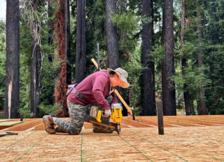 Rebuilding After CZU Woman using a tool on a construction site
