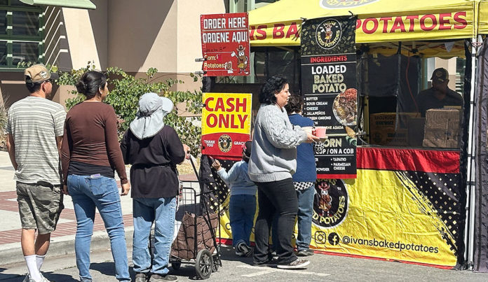 Watsonville Farmers Market Chilled by ICE Presence Four people lined up at a booth