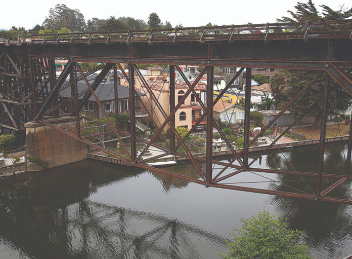 RTC Delays Rail Decision Old-fashioned wooden rail bridge high above a narrow river