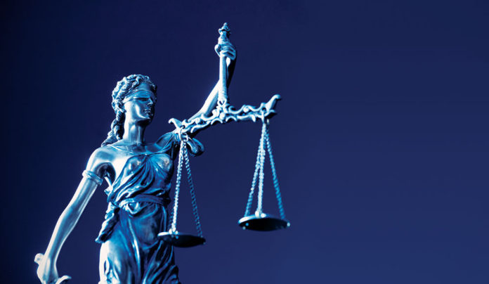 Santa Cruzan Indicted for Wire Fraud Statue of woman with scales of justice