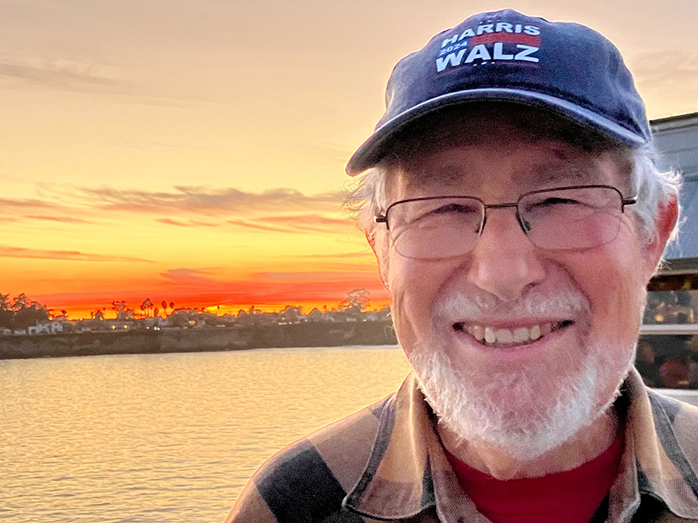 Older man in front of a beautiful sunset