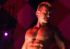 Exploring the Art of the Lap Dance Bare-chested man posing on a stage, with dramatic lighting