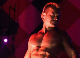 Exploring the Art of the Lap Dance Bare-chested man posing on a stage, with dramatic lighting