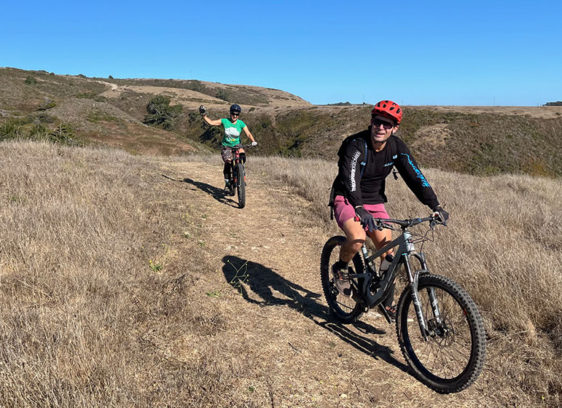 A bicyclist rides a dirt path at Cotoni Coast