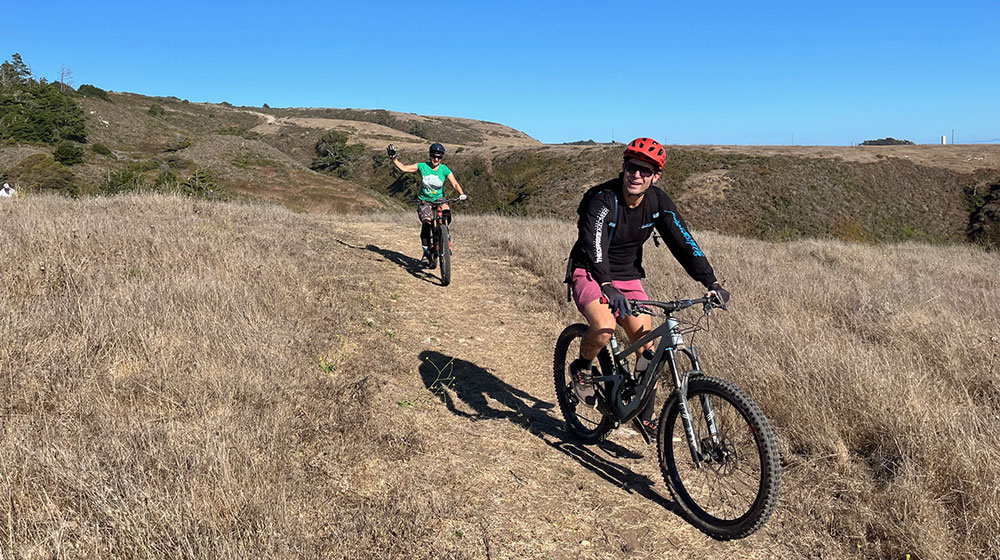 A bicyclist rides a dirt path at Cotoni Coast