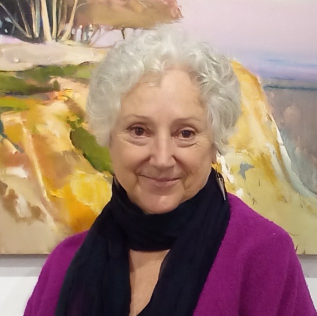Gallery owner Rose Sellery with black scarf and painting in background.