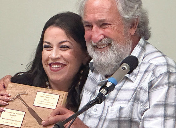 Local ACLU Chapter Holds Awards Luncheon Man and woman at an awards event, woman holding plaque