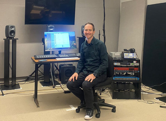 Diving into Immersive Audio at Cabrillo College Man sitting in a room surrounded by electronic equipment