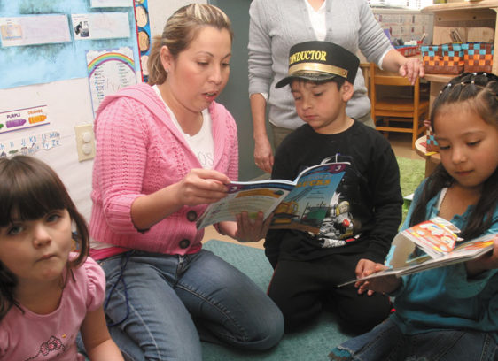 Head Start Programs Facing Layoffs, Closure Teacher with young students