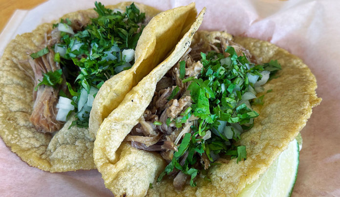 Casa de Masa a carnitas taco and tortas with traditional cilantro garnish