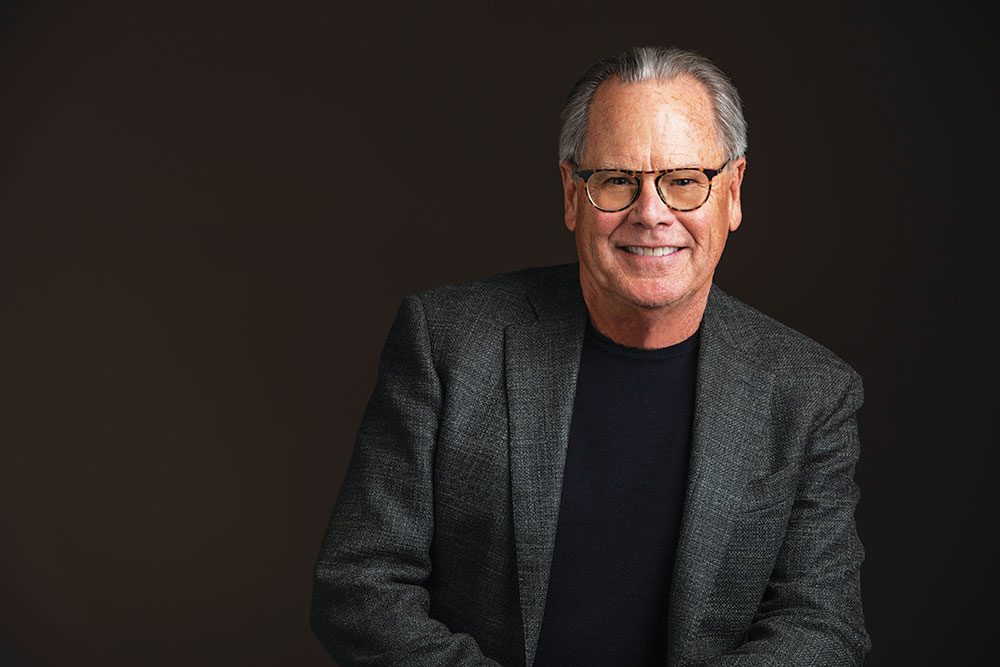 Formal portrait of a man on a black background