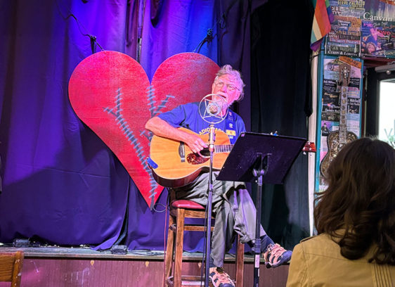 Open Mic Nights: Live, Loose and Local Man on a stage in a coffeehouse