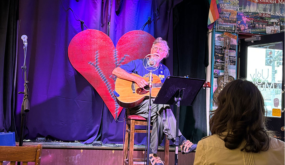 Man on a stage in a coffeehouse